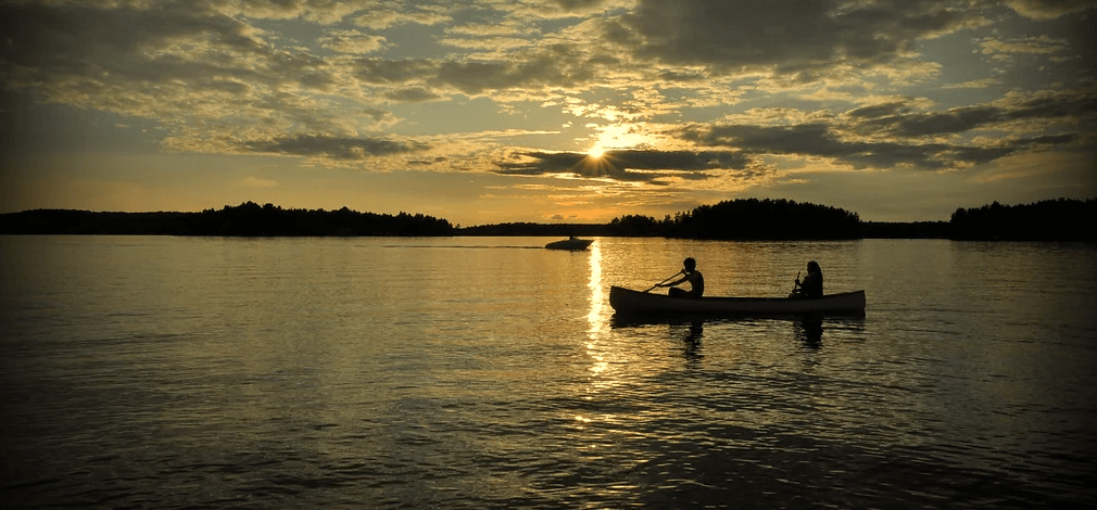 Couple canoeing on Horn Lake at sunset