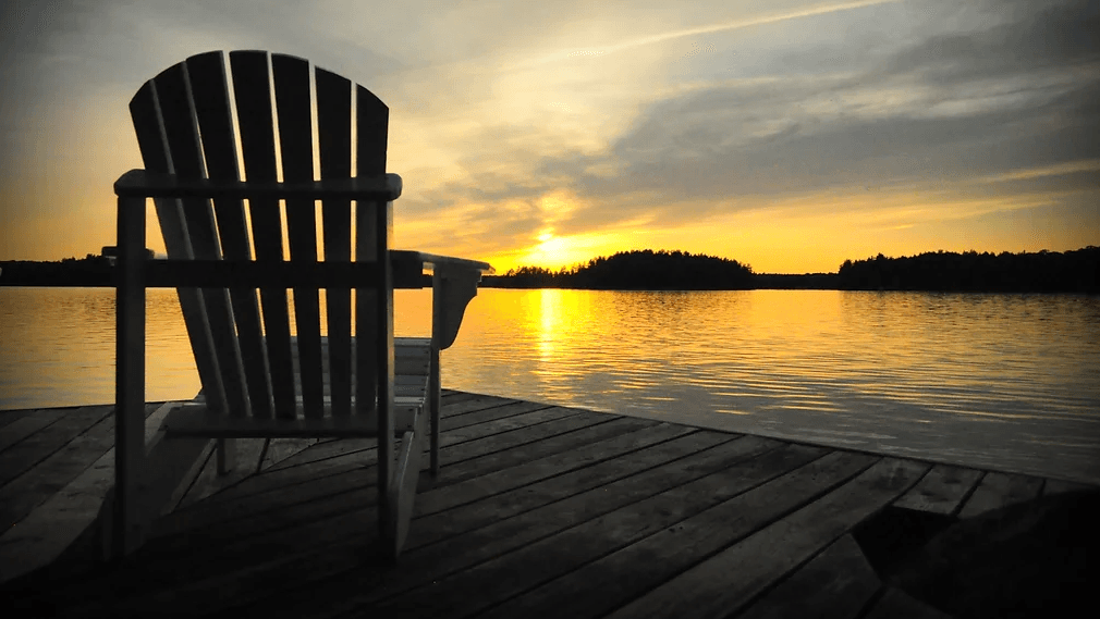 Muskoka chair on the dock at sunset on Horn Lake